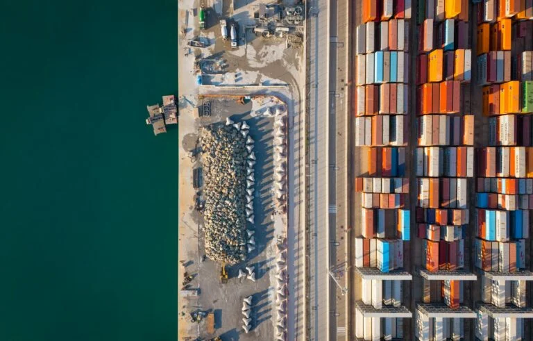 Aerial view of a busy port with colourful shipping containers